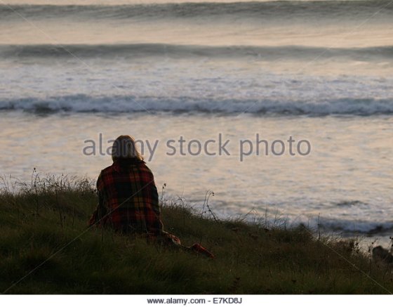 Woman wrapped in a blanket on cliff edge Psalm 27 Comfort Hurt Bible Ignatian Prayer