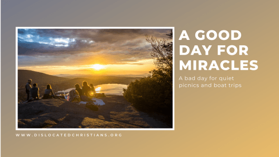 Friends picnicking on hill top in sunset