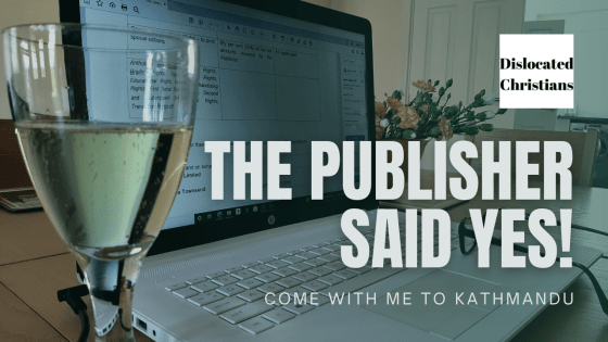 laptop, bubbly champagne, pair of glasses and flowers